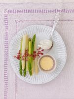 Asparagus with poached egg ham and mustard hollandaise on plate