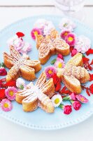 Close-up of butterfly, bee and dragonfly shaped biscuits served on plate