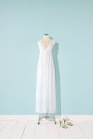 White long dress and necklace on mannequin