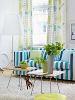 Blue and white striped sofa and curtains with leaf pattern in living room