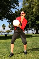 Black-haired woman in sportswear plays volleyball