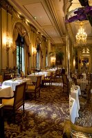 Tables laid in the restaurant Le Cinq at the Four Seasons George in Paris, France
