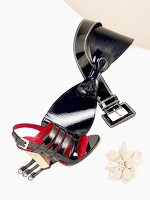 Black leather belt with bow and black sandals on side