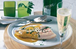Cod fillet with mustard butter and parsley on plate