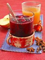 Baked apple wine punch and berry punch with star anise next to them