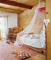 Kinderzimmer für Mädchen mit Moskitonetz über dem Bett