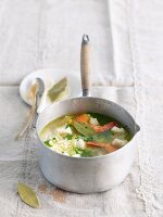 Fish, prawn and vegetable stew in a saucepan