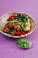 Stir-fried meatballs on a bed of spicy vegetables