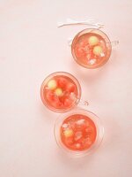 Three glasses of melon and cranberry rhubarb punch with ice cubes