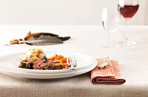 Saddle of venison with prune dumplings, mushroom sauce and carrots