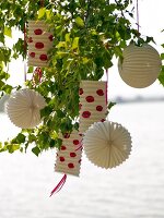 White lanterns on tree with red polka dots