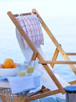 Close-up of wooden folding beach chair with pillow