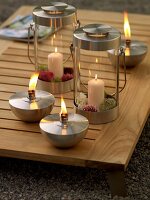 Close-up of table torches and glass lanterns on wooden table