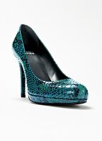 Close-up of green snake leather platform pump on white background