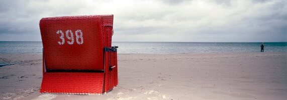 Red hooded beach chair on beach, Stralsund, Mecklenburg-Vorpommern, Germany