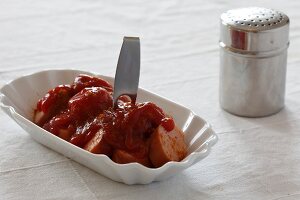 Currywurst in serving dish