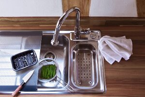 Kitchen sink with cutting board, elevated view