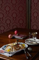 Guinea fowl with apples on plate for Christmas