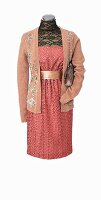 Cardigan over pink festive dress with lace on mannequin