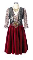 Sequined vest over floral patterned blouse and red velvet skirt on mannequin