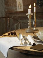 A table laid in a country house-style with burning candles