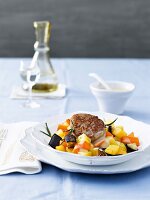 Pork medallions with carrot vegetables on plate