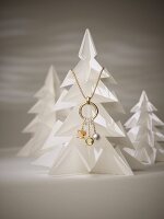 Gold necklace with pendants, pearl and diamonds on model of pine tree