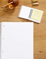 Notepad with blank pages, honey, globules and small notepad with note
