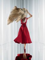 Rear view of Barbie wearing elegant red couture dress with bow