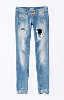Light blue skinny jeans on white background