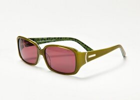 Close-up of olive green sunglasses on white background