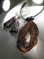 Silver chain with leather fringe and braided belt with crystal stone and pearls