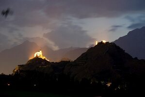 View of cityscape with two castle at dusk in Valais, Switzerland
