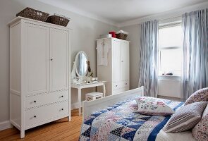 Bedrooms in Scandinavian style with dressing table, wardrobe and bed with cushions