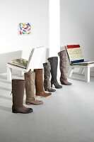 Row of various lined boots and small chair