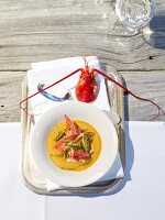 Pot-au-feu lobster in serving bowl