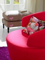 Pink contemporary swivel arm chair and romantic stool on purple mat