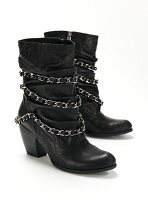 Biker boots with silver chains on white background