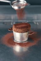 Dusting cocoa powder on chocolate souffle