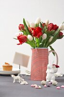 Red and white striped jug with tulips and bunny figurines made of porcelain