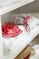 Sachets in linen closet on white surface