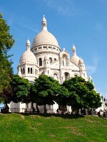 People relaxing in front of Sacre Coeur with blue sky, Paris, France