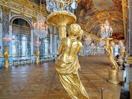 Hall of Versailles Palace with mirrors, frescoes and chandelier in France