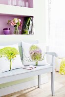 Photo print cushions on white wooden bench