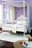 Canopied bed in bedroom with lilac walls