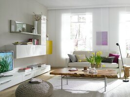 White living room with coffee table made up of maple wood