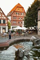 View of Market place, half-timbered houses and fountain in Ladenburg, Germany