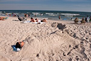 People relaxing on beach, New York, USA