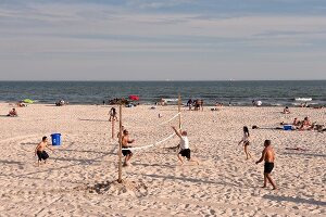 People relaxing on beach, New York, USA