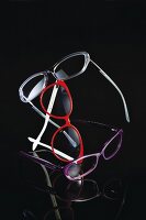 Various eyeglass frames on black background